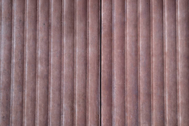 Corrugated metal roller shutter texture. Vivid red steel door for background.