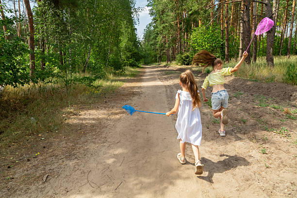 a multigenerational family is camping in a park by the river, capturing the family activity during an outdoor adventure