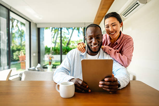 istock Remote work and digital business. Diverse couple collaborating online, managing projects with laptop 2237996660