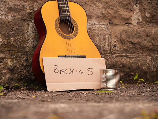 Street busker guitar goes for lunch break medium shot selective focus