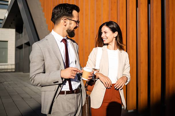 istock Business people talking and smiling during coffee break outside office 2238003544