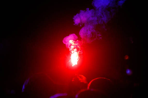 istock A red and blue firework is lit in the dark 2238003729