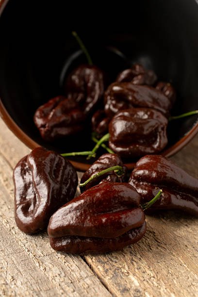 istock Brown habanero peppers on rustic wooden table, vertical shot 2238003967