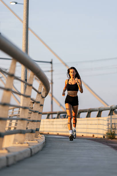 istock Young woman running in urban area 2238005253