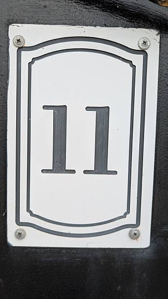 The number 11 is prominently featured on a stark black background, creating a striking visual