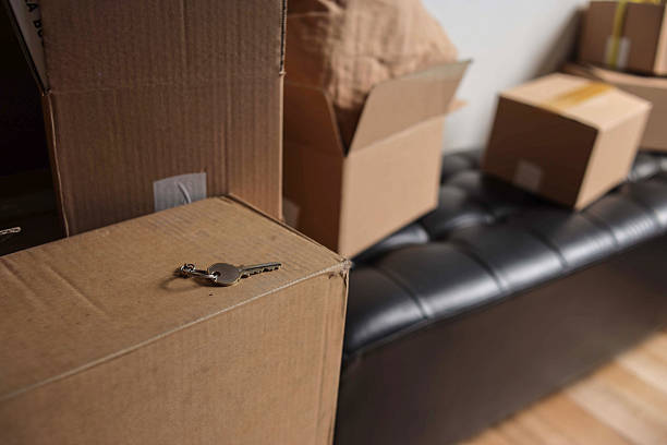 istock House Keys Rests on Cardboard Moving Box With Other Boxes on New Home 2238006483