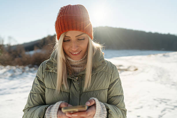 istock Young woman using mobile phone outdoors 2238006564