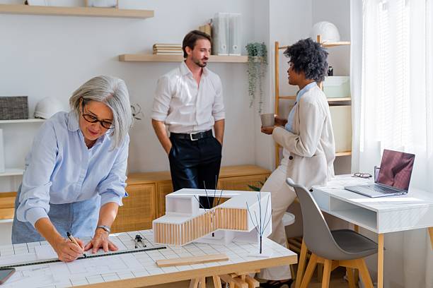 istock Architects designing building model with diverse team collaborating in office 2238007473