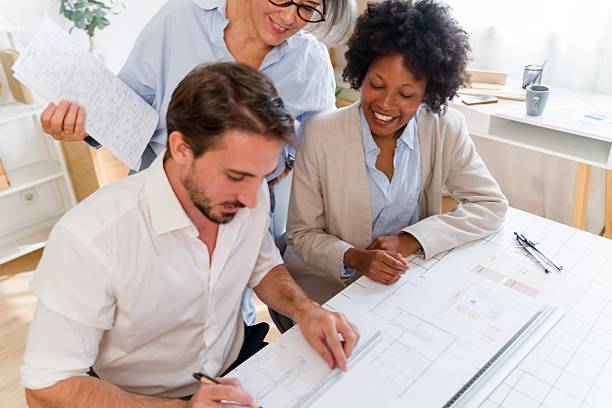 istock Architects team collaborating on new building design blueprint 2238012452