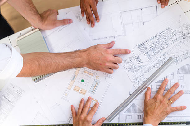 istock Architects collaborating on building plans and house designs 2238013472