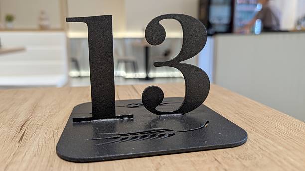 3D rendering of Number 1 made of Dark Turquoise colored Faceted Translucent Glass material, illuminated by Glowing Neon Lighting from within that produce a Holographic Effect, isolated on white background.