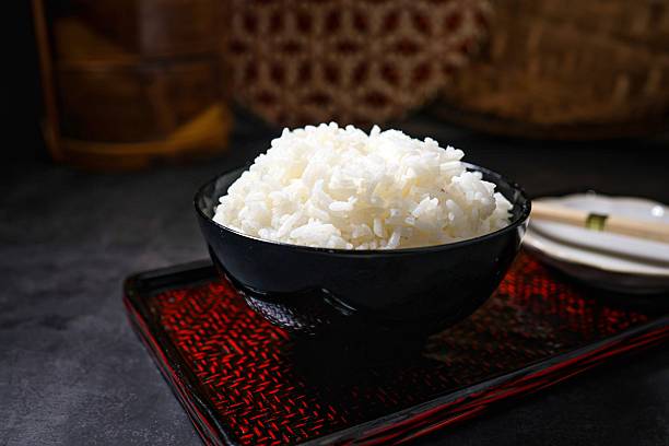 istock Cooked white rice or steamed rice inn a black bowl 2238014883