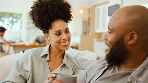 istock Couple At Home Sitting Talking on Sofa Smiling Enjoying A Sofa 2238016922