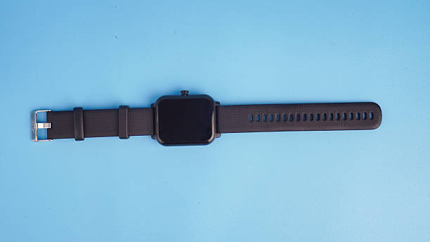 istock Close-up of a black smartwatch isolated on a light blue background 2238017132