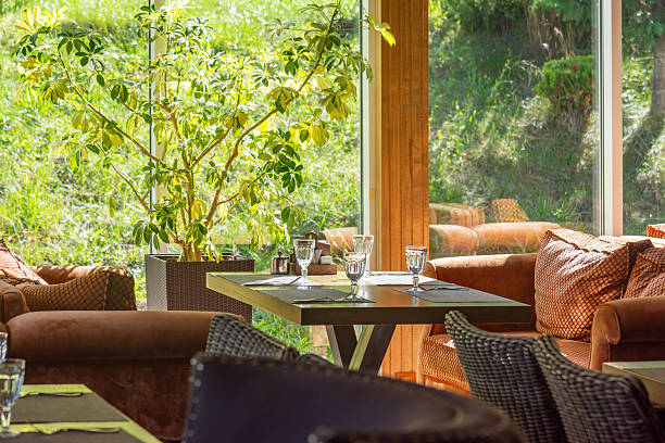 istock Restaurant interior and Cozy seating area with garden view. Soft lighting and plants create a relaxing ambiance. 2238017161