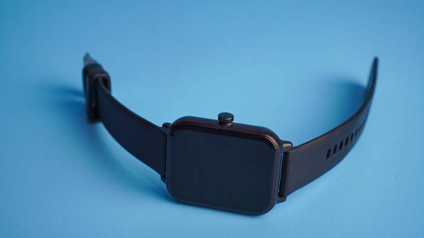 istock Close-up of a black smartwatch isolated on a light blue background 2238017410