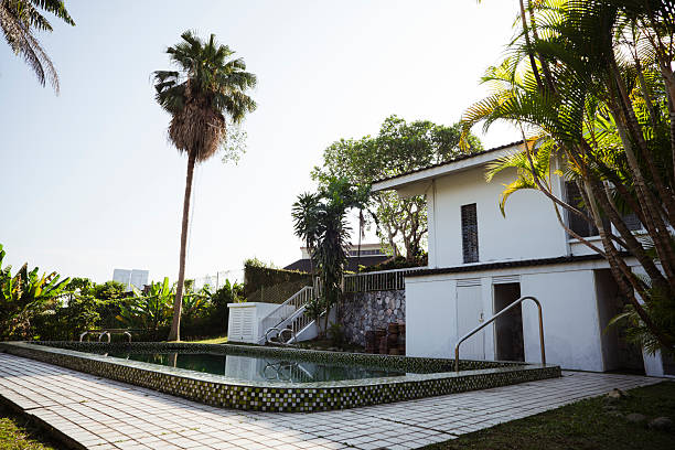 A peaceful tropical-style residence featuring a swimming pool and surrounded by dense greenery. Ideal for concepts of luxury property, wellness, and serene lifestyle.