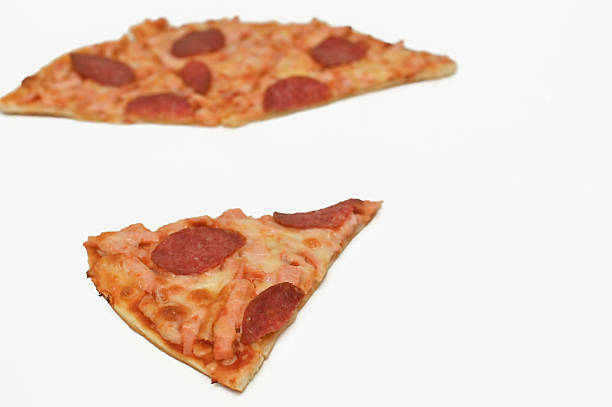 istock pizza slices with melted cheese and pepperoni topping isolated on white. 2238021747