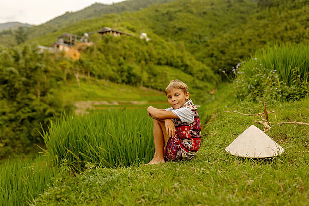 Family with children, cute blond boy, visiting Sapa rice fields on a sunny day
