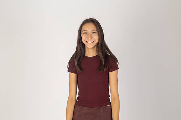 Girl is standing and smiling at the camera.