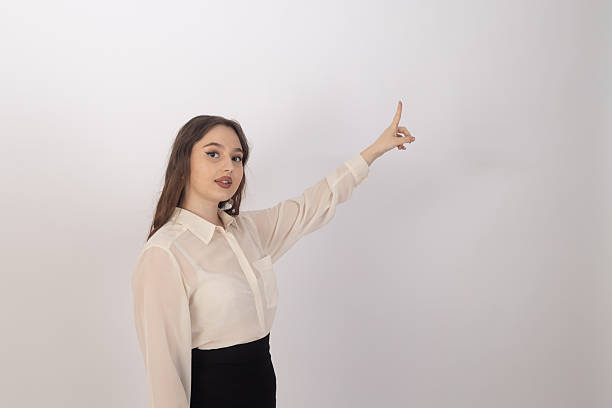 istock Woman is pointing upwards with her right hand 2238024040