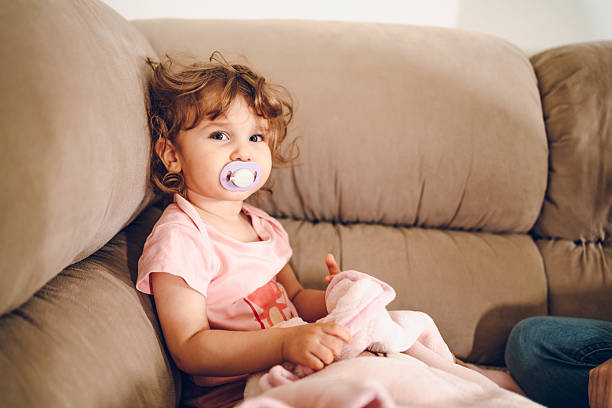 Cute little girl enjoy at home. She looking at camera.