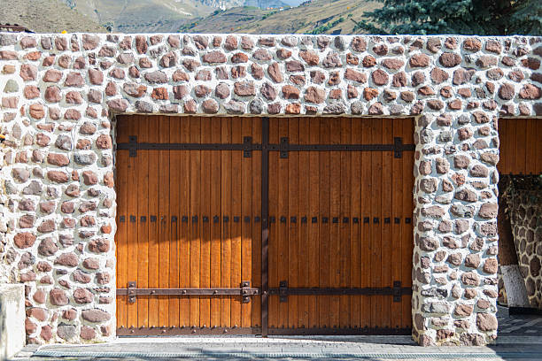 istock cobble stone wall with a massive wooden gate. copy space. 2238026112