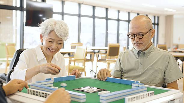 istock Asian elderly people playing mahjong in a care home 2238027743