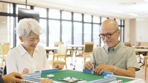 istock Asian elderly people playing mahjong in a care home 2238027746