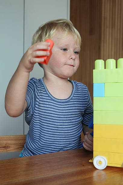 istock child playing with  building blocks indoors. 2238029013