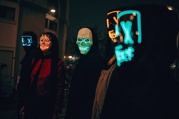 istock People in illuminated masks gathered during a nighttime city event 2238029620
