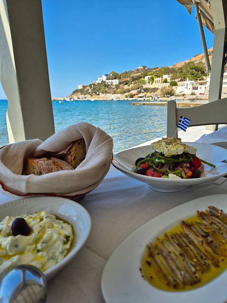 istock Greek food on a table, overlooking the sea 2238029861