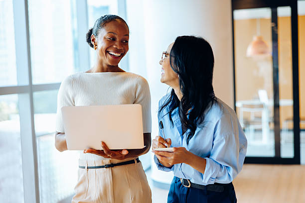 istock Two businesswomen discussing ideas using a laptop and taking notes in an office 2238030822