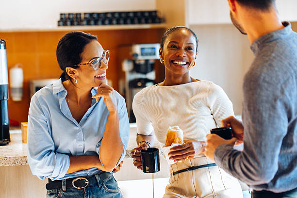 istock Group of coworkers chatting informally while enjoying coffee in the office kitchen 2238032008