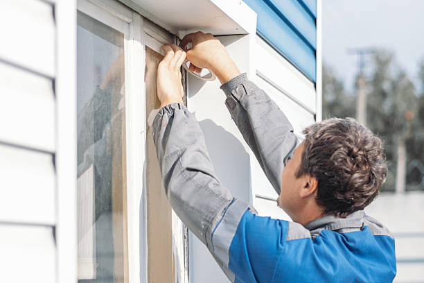 istock Man Sealing Window Frame with Caulk Outdoors 2238032171