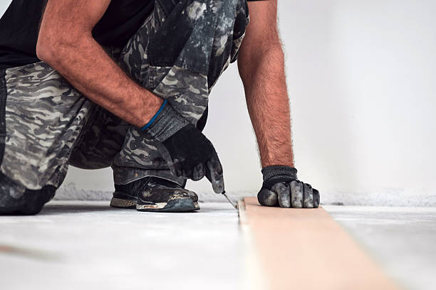 istock Professional handyman installing laminate flooring in a new apartment. 2238032270