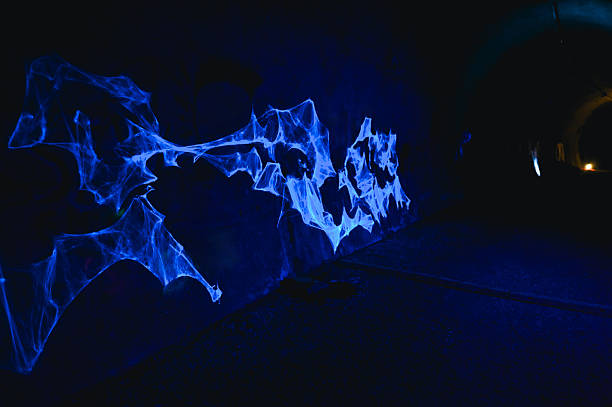 Abstract blue light installation creating a glowing pattern in a dark tunnel