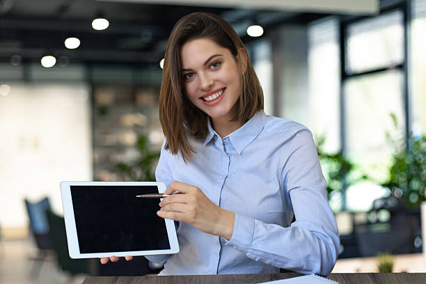 istock Young happy business woman showing blank tablet computer screen in office. 2238039076