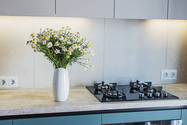 istock Modern kitchen. Bouquet of white daisies in vase on table 2238040083