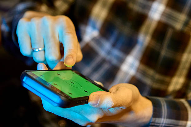 istock Man scrolling smartphone in plaid shirt indoors 2238041284
