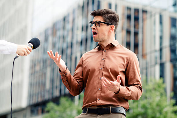 istock Young professional being interviewed outdoors in a modern city environment wearing stylish attire and gesturing confidently 2238044150