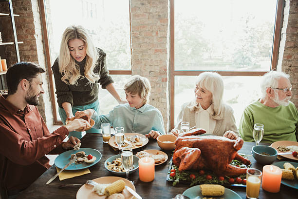istock A funny creative family gathering at thanksgiving big generation sharing feast laughter around table turkey kids parents grandparents friends 2238045630