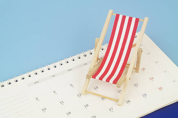 istock Red beach chair on calendar on blue background. 2238048717
