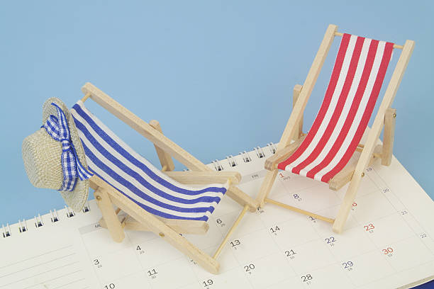 istock Red and blue beach chairs with hat on calendar on blue background. 2238048827