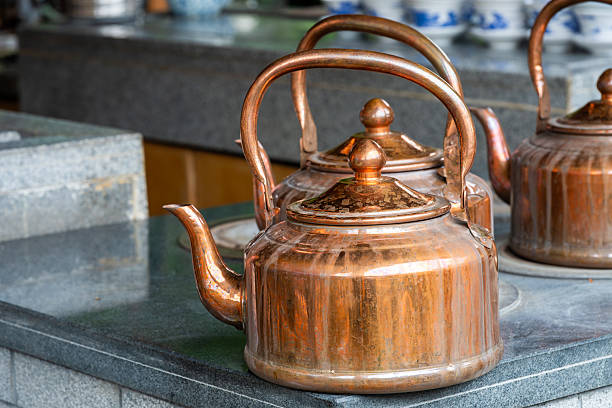 istock Traditional copper kettles resting on a stone counter 2238049831