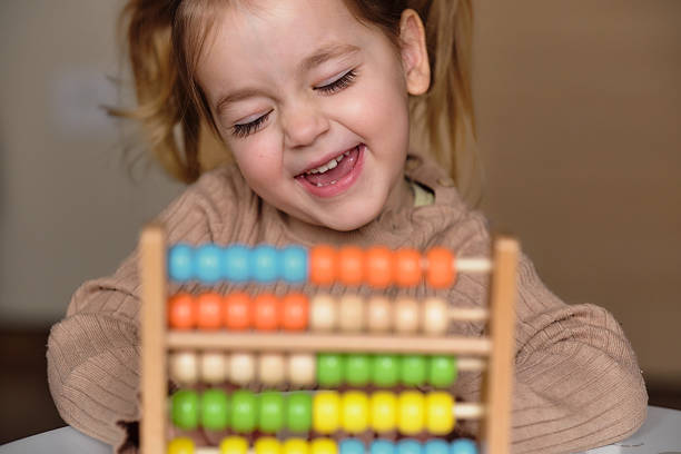 istock Girl smiling and learning math with abacus toy. 2238052121