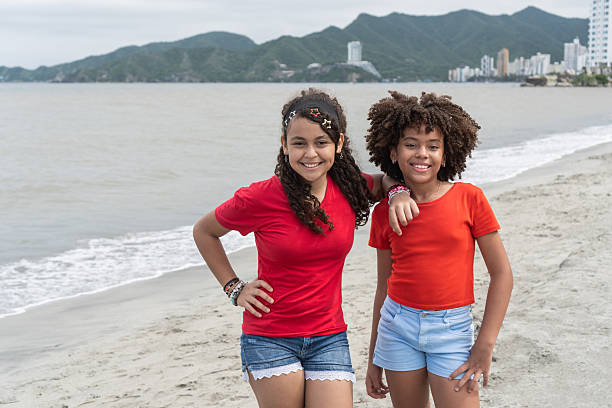 istock Happy girls smiling at beach during vacation 2238053304
