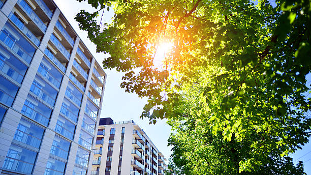 Modern block of flats in green area, residential apartment and luxury house complex.