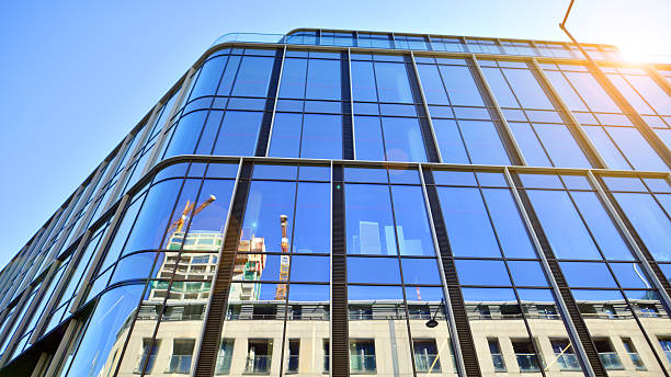 istock Modern office building with glass facade on a clear sky background. 2238053405