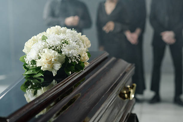 istock Group of Middle Aged People Mourning Beside Coffin during Funeral Ceremony 2238055656